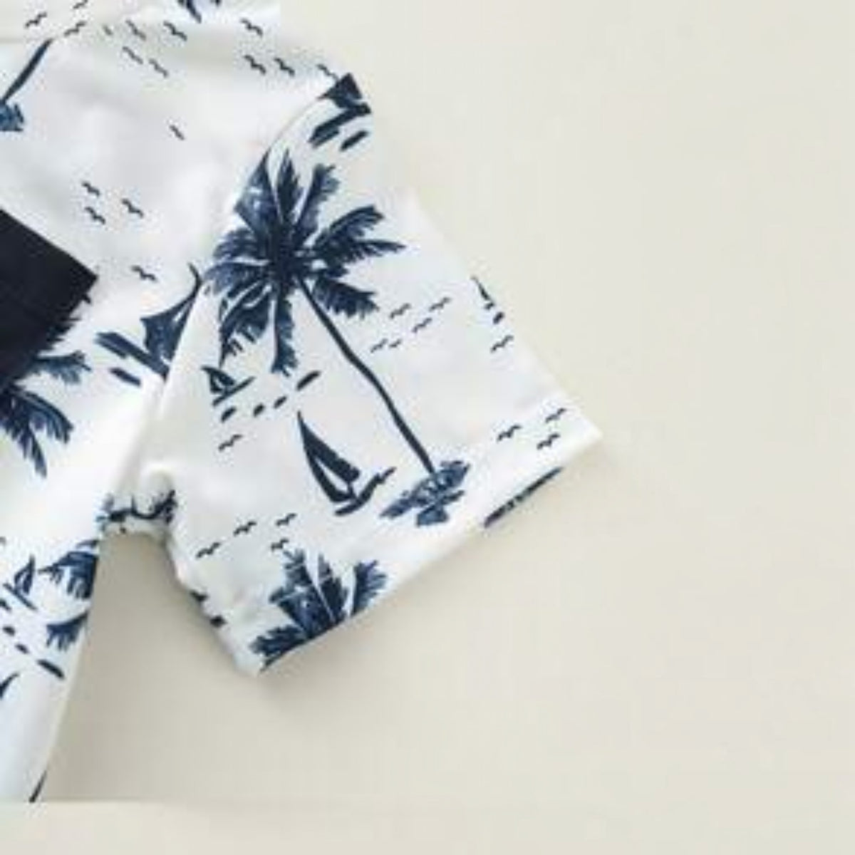 Babylove Nauru baby boy white short sleeve top with navy blue coconut tree and sailboat print and pocket detail