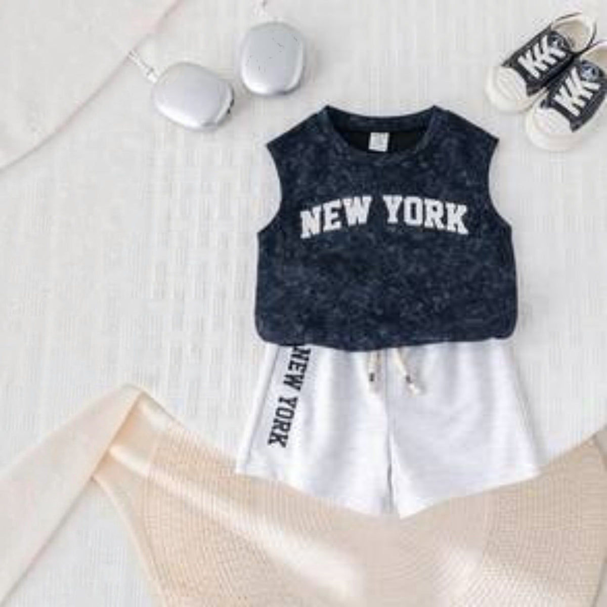 Babylove Nauru toddler boy summer outfit with navy acid-wash vest top and white shorts featuring New York print