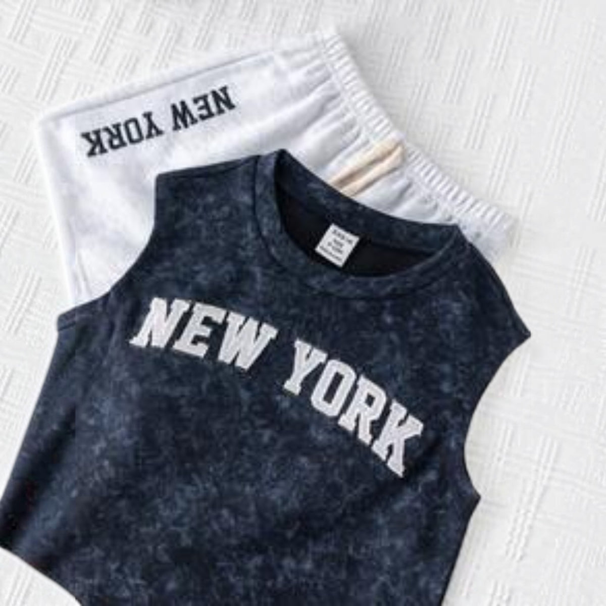 Babylove Nauru toddler boy summer outfit featuring a navy acid-wash vest and white shorts with New York lettering.